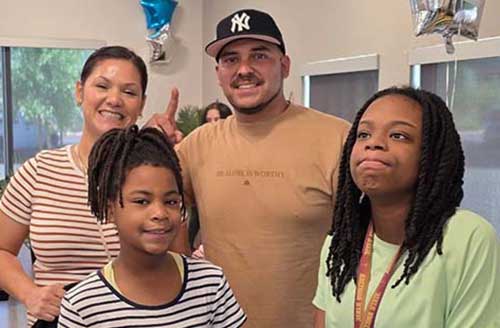 Diverse group celebrating at Gorman & Company USA community event, promoting housing and social initiatives.